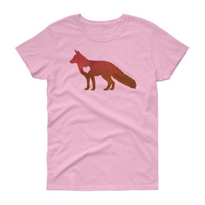 May include: A pink women's t-shirt with a watercolor silhouette of a fox with a heart in its chest. The fox is in shades of orange and red.