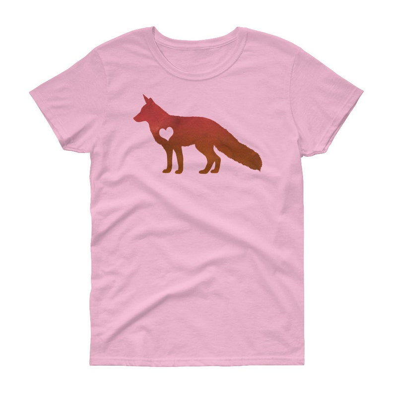 May include: A pink women's t-shirt with a watercolor silhouette of a fox with a heart in its chest. The fox is in shades of orange and red.