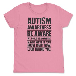 a pink t - shirt with the words autism awareness be aware