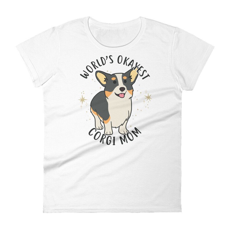 May include: White t-shirt with a black and white cartoon corgi dog and the text "World's Okayest Corgi Mom".