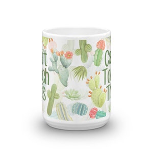 May include: White ceramic mug with a cactus print and the text "Can't Touch This" on the side.