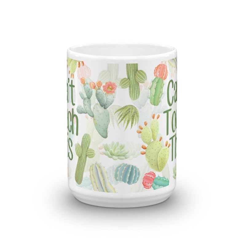 May include: White ceramic mug with a cactus print and the text "Can't Touch This" on the side.