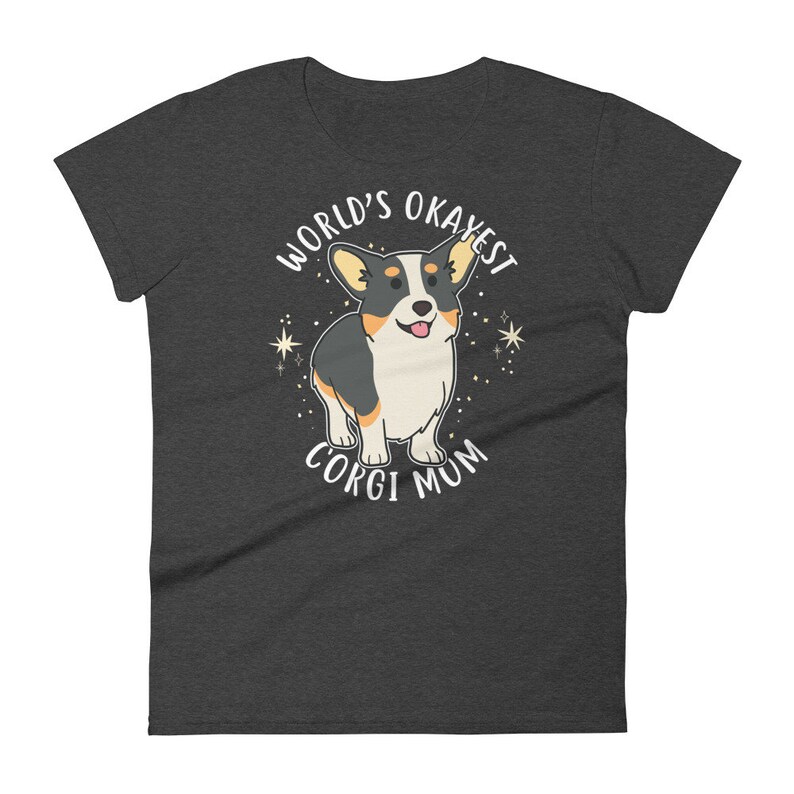 May include: Dark gray t-shirt with a white graphic of a cartoon corgi dog. The text "World's Okayest Corgi Mum" is printed on the shirt.