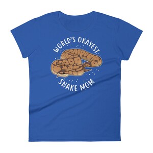 May include: A royal blue t-shirt with a white circle design featuring a cartoon snake and the text "World's Okayest Snake Mom".