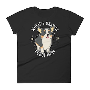 May include: Black women's t-shirt with a white graphic of a corgi dog and the text "World's Okayest Corgi Mum".
