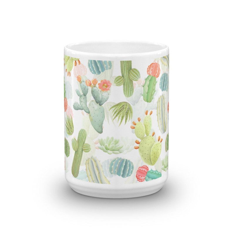 May include: White ceramic mug with a colorful cactus pattern. The mug features a variety of cacti in shades of green, pink, and orange.