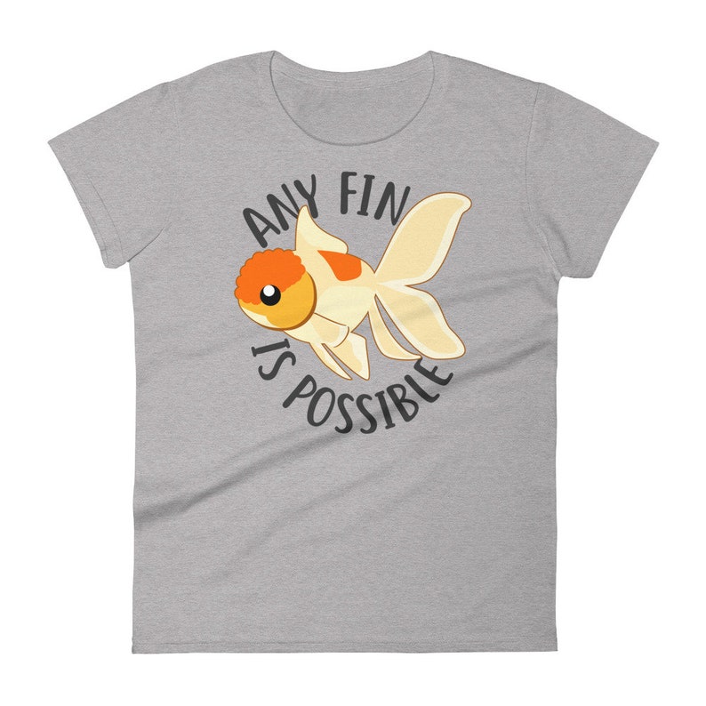 May include: A gray t-shirt with a cartoon goldfish and the text "Any fin is possible".
