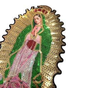 May include: A gold and green sequined iron-on patch featuring a depiction of the Virgin Mary. The patch is surrounded by a gold halo and has a pink rose at the bottom.