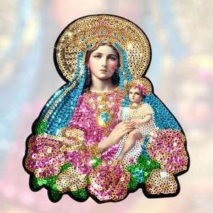May include: A colorful sequined patch depicting the Virgin Mary holding a baby Jesus. The patch features a gold halo, blue and pink robes, and a floral design.