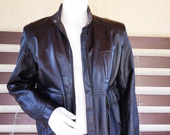 May include: A black leather jacket with a zipper closure and multiple pockets. The jacket has a stand-up collar and a slightly fitted silhouette.