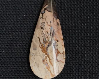May include: A teardrop-shaped pendant made of brown, white, and gray agate with a swirling pattern.