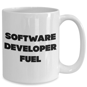 May include: White ceramic coffee mug with black text that reads "SOFTWARE DEVELOPER FUEL".