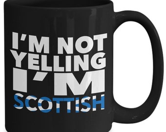 May include: Black coffee mug with white text that reads "I'm not yelling I'm Scottish" with a blue and white Scottish flag design.
