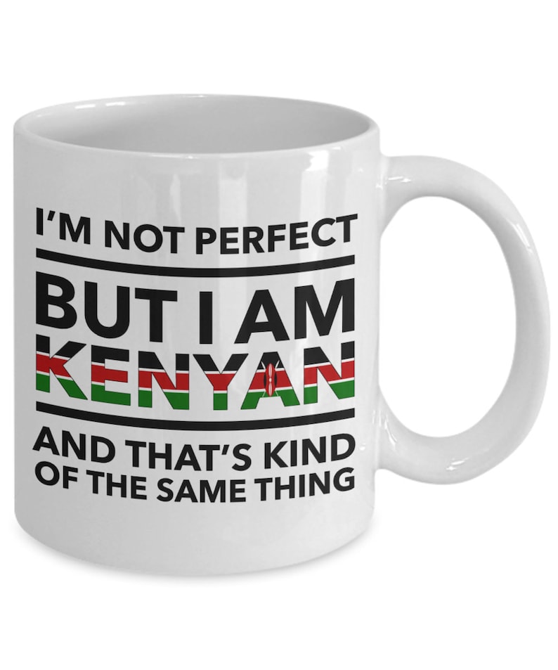 May include: White ceramic coffee mug with black text that reads "I'm not perfect but I am Kenyan and that's kind of the same thing". The word "Kenyan" is in black with the Kenyan flag colors in the background.