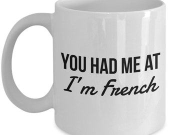 May include: White ceramic coffee mug with black text that reads "You had me at I'm French".