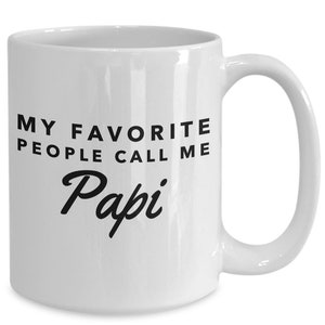 May include: White ceramic coffee mug with black text that reads "My favourite people call me Papi".