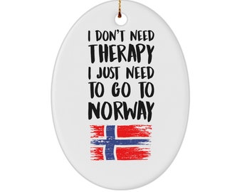 May include: White oval ceramic ornament with the text "I don't need therapy I just need to go to Norway" in black text. The Norwegian flag is below the text in red, white, and blue.