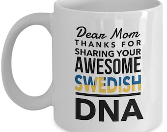May include: White ceramic coffee mug with a black design that says "Dear Mom Thanks for sharing your awesome Swedish DNA". The text is in a black font with a yellow and blue stripe under the word "Swedish".
