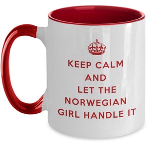 May include: White ceramic mug with a red rim and handle. The mug has a red crown and the text "Keep Calm and Let the Norwegian Girl Handle It" printed on it.