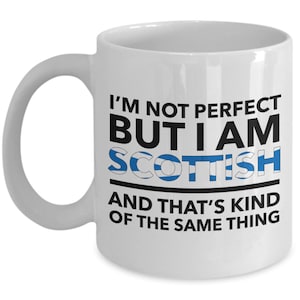 May include: White ceramic coffee mug with a black and blue design. The mug reads "I'm not perfect but I am Scottish and that's kind of the same thing".