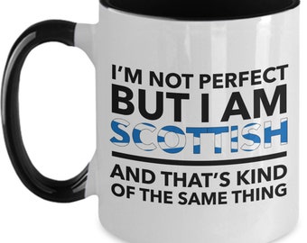 May include: White ceramic coffee mug with a black interior and handle. The mug features a black and blue graphic with the text "I'm not perfect but I am Scottish and that's kind of the same thing."