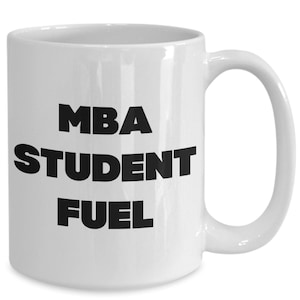 May include: White ceramic coffee mug with black text that reads "MBA Student Fuel".