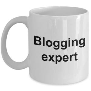 May include: White ceramic coffee mug with black text that reads "Blogging expert".