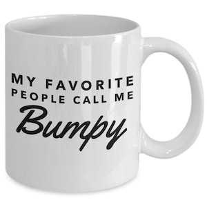 May include: White ceramic coffee mug with black text that reads "My favorite people call me Bumpy".