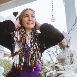 Boho festival outfit featuring long feather drop earrings handmade natural statement accessory