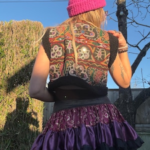 Cropped black faux fur hippie vest styled as festival outfit