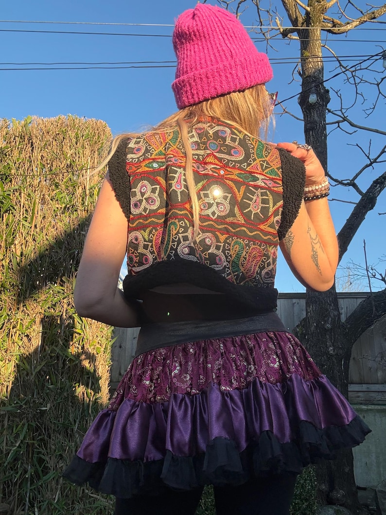 Cropped black faux fur hippie vest styled as festival outfit