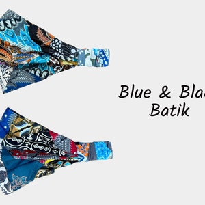 May include: Two blue and black batik fabric headbands. The fabric is a patchwork of different patterns and colors. The headbands are elastic and can be worn in a variety of ways.