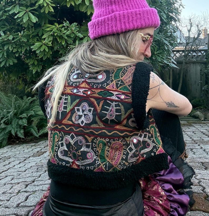 Handmade black boho waistcoat with vintage Indian mirror embroidery detail closeup