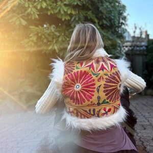 One-of-a-kind yellow boho vest with colorful vintage textiles and faux fur trim