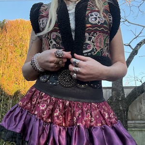 Black faux fur vest with embroidered mirrored antique Indian textiles, front view