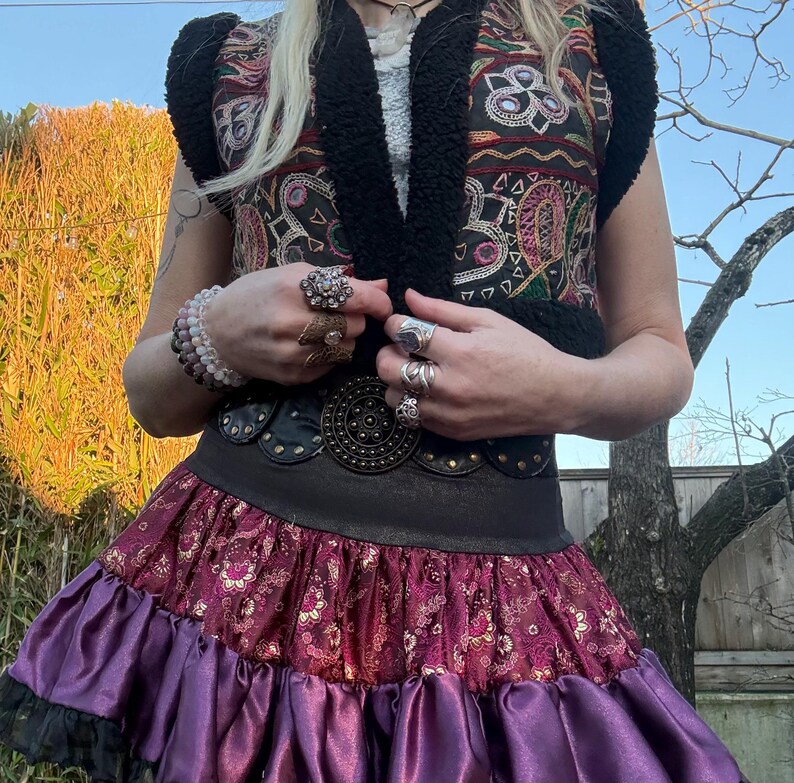 Black faux fur vest with embroidered mirrored antique Indian textiles, front view