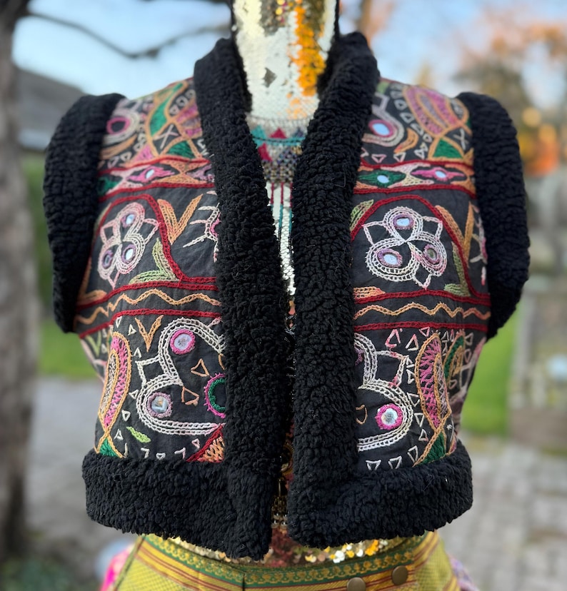 Black faux fur festival vest with vintage mirror embroidery, detail shot