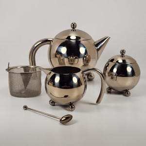 Tetera Henley Atomic Art Deco de acero inoxidable con colador, azucarero y cuchara.