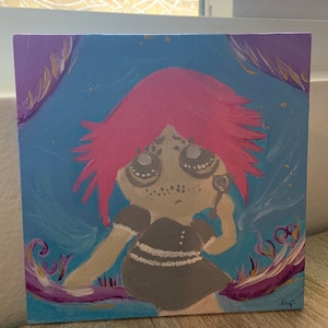 May include: A painting of a girl with pink hair and big eyes. She is wearing a black dress with white trim. The background is a blue and purple swirl.