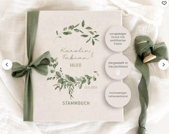 May include: A cream-colored linen-bound book featuring a green watercolor leaf wreath design. The text reads Karolin & Fabian MEIER, 15.5.2025, and STAMMBUCH. The book is tied with a sage green fabric ribbon and includes three circular informational labels.