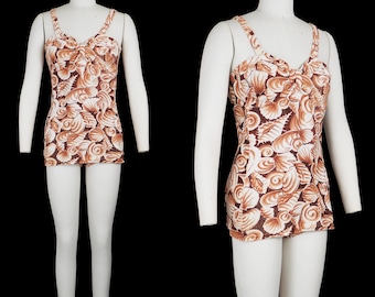 May include: A vintage brown and white swimsuit with a seashell pattern. The swimsuit has a halter top and a skirt.