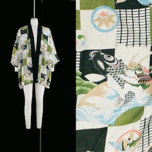 Pode incluir: Um quimono verde e preto com um padrão xadrez e imagens de inspiração japonesa, incluindo peixes koi, uma grue e uma flor. O quimono tem uma bainha preta e é feito de um tecido leve.