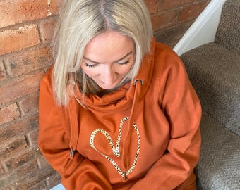 Cowl neck hoodie in orange with leopard heart print