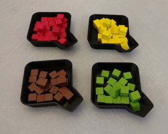 May include: Four black trays with a spout, each filled with a different colour of small wooden cubes. The trays contain red, yellow, brown, and green cubes.