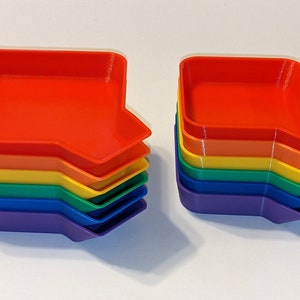 Side view of rainbow token tray stack showing the bagging funnel on the corner of each tray.