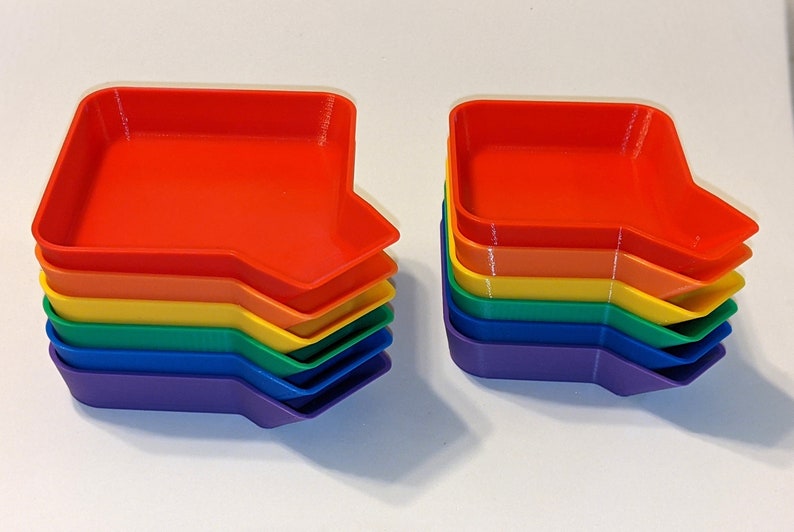 Side view of rainbow token tray stack showing the bagging funnel on the corner of each tray.