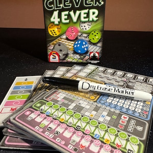 May include: A board game called "Clever 4ever" by Wolfgang Warsch, with a black box and colorful dice. The game board is made of gray plastic with a dry erase marker and a stack of score sheets.