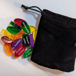 Disney Villainous random tokens (28) with their velvet bag to help choose a random villain to play. Shown alongside the velvet bag.