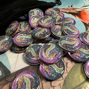 Wyrmspan dragon coins coming out of a black velvet bag. This is the coin sticker set by LaserLand.