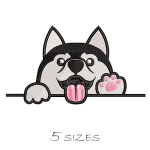 May include: Embroidered design of a cartoon husky dog peeking over a surface with its tongue sticking out and a paw raised. The dog is black and white with a pink tongue and paw.